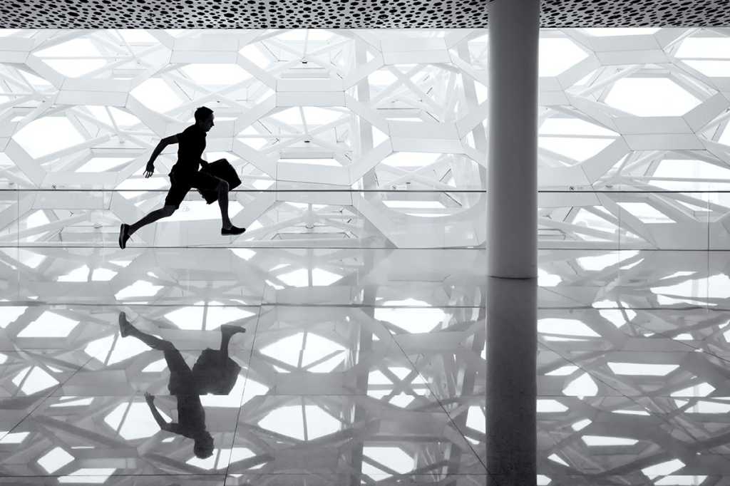 a man runs through an abstract background