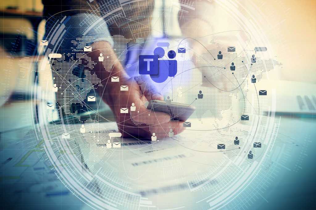 Virtual security technology focuses on the Microsoft Teams logo as someone uses his mobile phone.