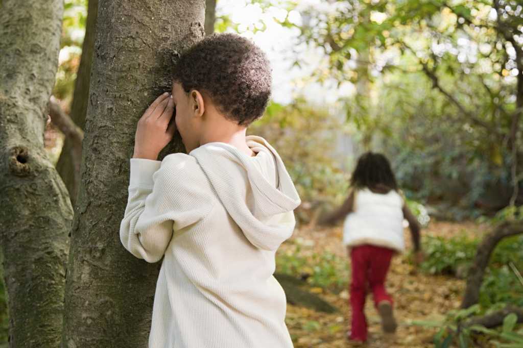 young boy hide and seek game hiding