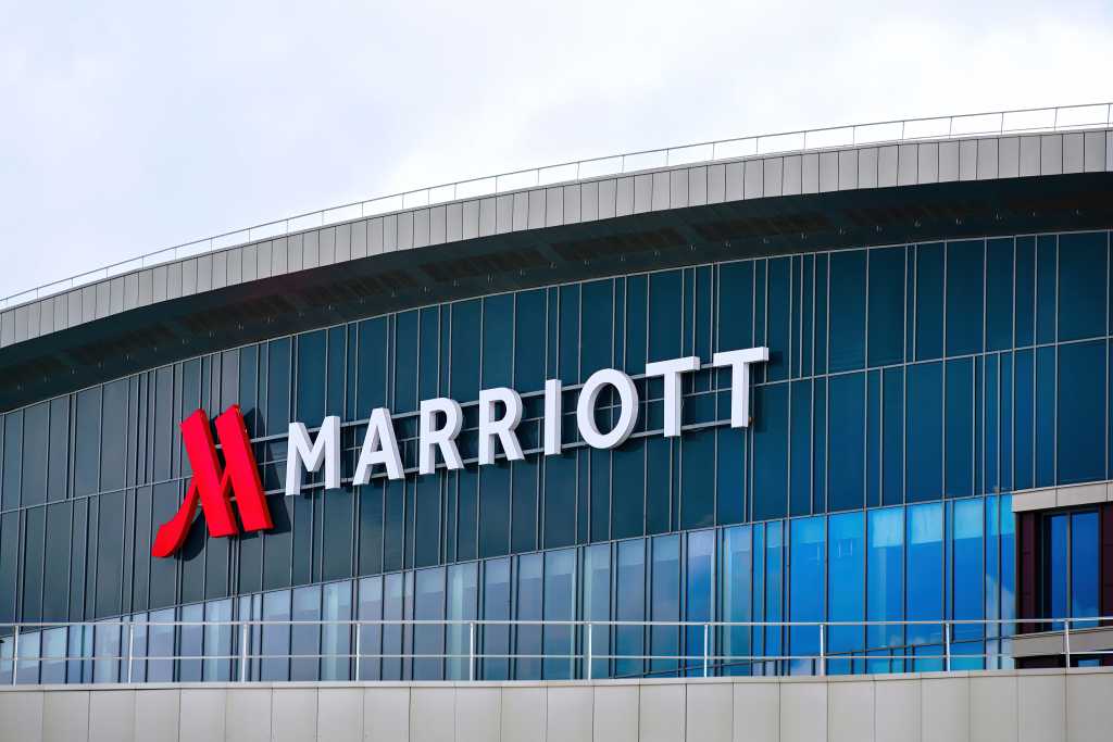 Minsk, Belarus. May 2022. Marriott hotel sign on modern glass facade. Marriott International, Inc. is an American multinational company, that operates, franchises, and licenses lodging